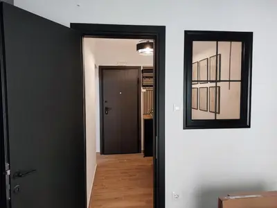 a hallway with a mirror on the wall and a door at Renovated appartment, near Metro in Athens