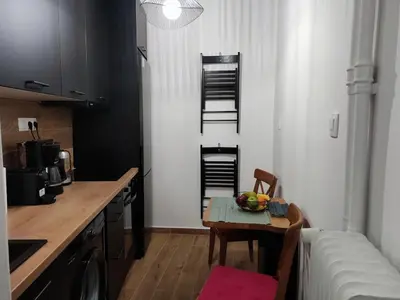 a small kitchen with a table and a kitchen with a couch at Renovated appartment, near Metro in Athens