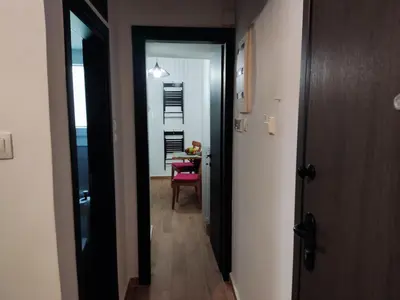 a hallway with a door leading to a room with a table at Renovated appartment, near Metro in Athens