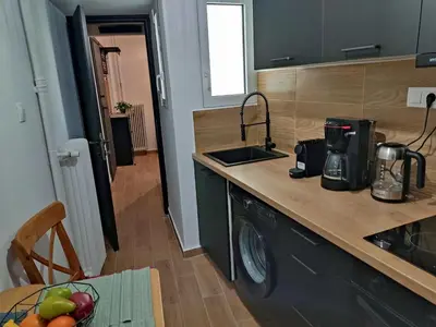 a kitchen with a sink and a counter top at Renovated appartment, near Metro in Athens