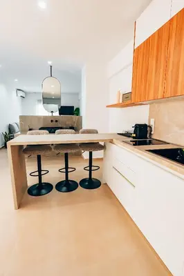 a kitchen with a table and two bar stools at Luxury Superior Suite in Glyfada in Athens