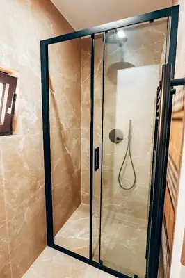 a shower with a glass door in a bathroom at Luxury Superior Suite in Glyfada in Athens