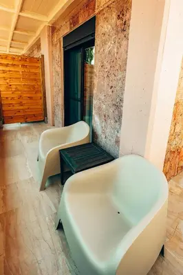 a bathtub and a bench in a room at Luxury Superior Suite in Glyfada in Athens