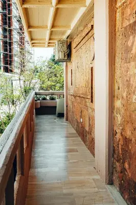 an empty hallway of a building with a chair on a balcony at Luxury Superior Suite in Glyfada in Athens