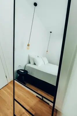 a bedroom with a bed in a mirror at Dreamy Glyfada Apartment in Athens