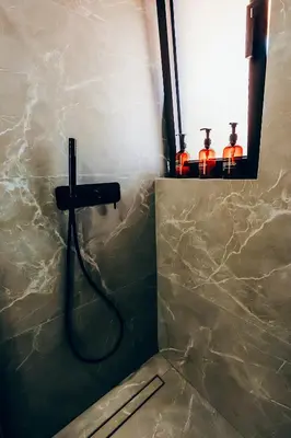 a bathroom with a shower with a faucet at Dreamy Glyfada Apartment in Athens