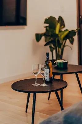 a table with two glasses and a bottle of wine at Dreamy Glyfada Apartment in Athens