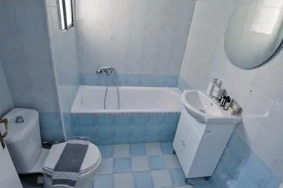 a bathroom with a toilet and a tub and a sink at Seren Studio near Victoria Metro-Earthy Tones & Comfort in Mesochórion