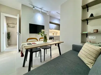 a living room with a dining room table and a couch at Larisis Cozy Corner in Athens