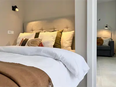 a bedroom with a large white bed with pillows at Larisis Cozy Corner in Athens