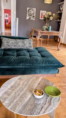 a living room with a green couch and a table at Avenue of Gods - Irakli's Retreat in Athens