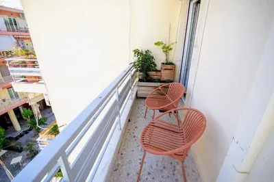 two orange chairs sitting on a balcony at Avenue of Gods - Irakli's Retreat in Athens