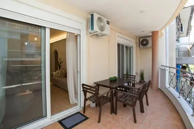 a dining room with a table and chairs and a balcony at K11 Apartment in Athens