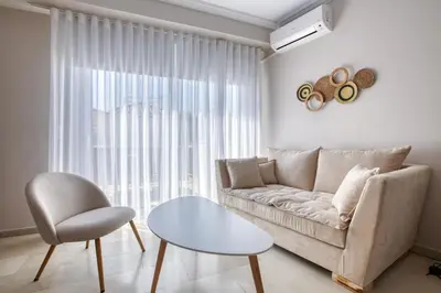 a living room with a couch and a chair at Avra - Topfloor apartment in historical Athens in Athens