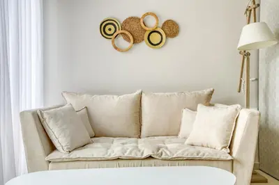 a living room with a couch and some plates on the wall at Avra - Topfloor apartment in historical Athens in Athens