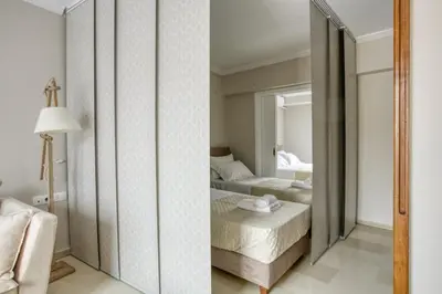 a bedroom with two beds and a mirror at Avra - Topfloor apartment in historical Athens in Athens