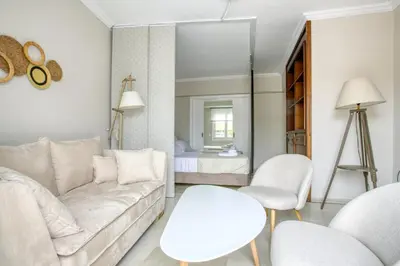 a living room with a couch and a table and chairs at Avra - Topfloor apartment in historical Athens in Athens
