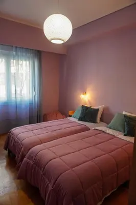 a bedroom with a large bed with a red blanket at The Green Apartment Athens in Athens