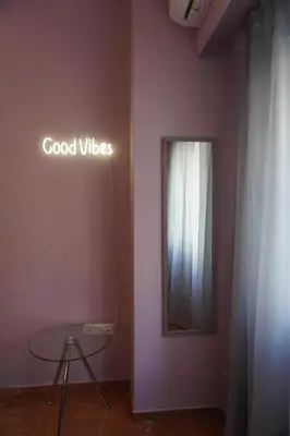 a room with a table and a sign on the wall at The Green Apartment Athens in Athens
