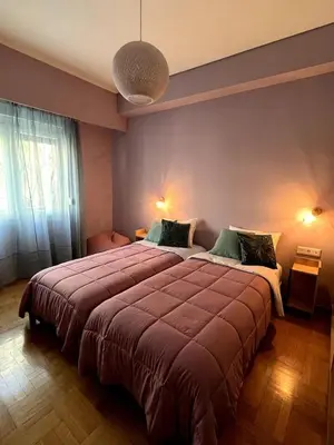 a bedroom with a large bed in a room at The Green Apartment Athens in Athens