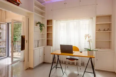 a room with a desk with a laptop on it at Rafael Apartment Ampelokipoi in Athens