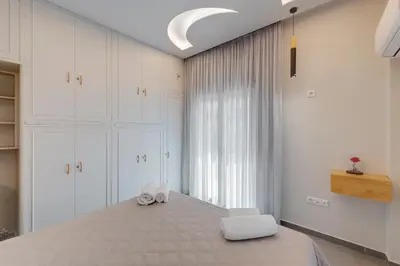 a bedroom with a large bed with two towels on it at Rafael Apartment Ampelokipoi in Athens