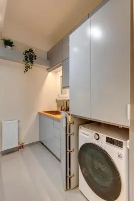 a kitchen with a washing machine in a white kitchen at Rafael Apartment Ampelokipoi in Athens