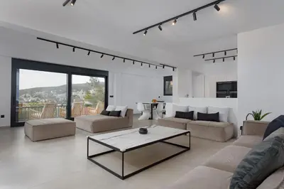 a living room with a couch and a coffee table at Athenian Black Villa in Saronida