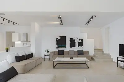 a living room with a couch and a coffee table at Athenian Black Villa in Saronida