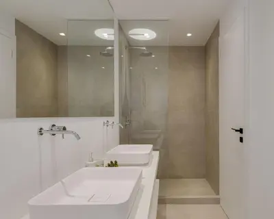 a white bathroom with a sink and a shower at Athenian Black Villa in Saronida