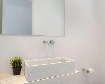a white sink in a white bathroom with a mirror at Athenian Black Villa in Saronida
