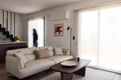 a living room with a couch and a table at Ikima Living in Piraeus