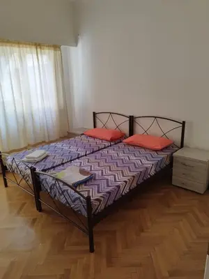 a bedroom with a bed with red pillows on it at Berry room 2 in Athens