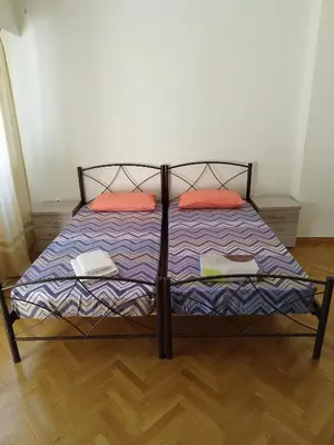 a bed with two pillows on it in a room at Berry room 2 in Athens