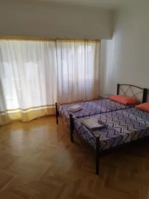 a bedroom with two beds and a large window at Berry room 2 in Athens