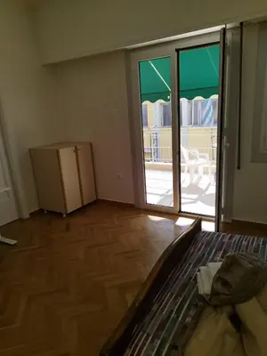 a room with a bed and a sliding glass door at Berry room 2 in Athens