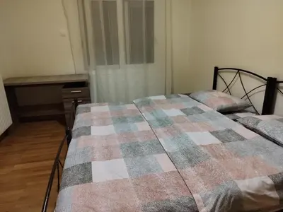 a bedroom with a bed with a checkered blanket at Berry room 5 in Athens