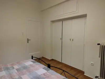 a bedroom with white cabinets and a bed at Berry room 5 in Athens