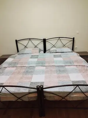 a bed with a quilt and pillows on it at Berry room 5 in Athens