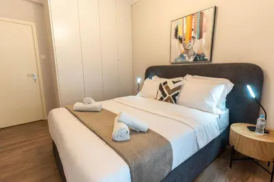 a bedroom with a large bed with towels on it at Athenian Secret Key Residence in Athens