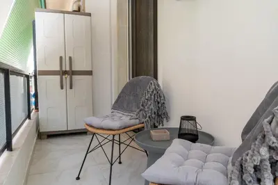 a room with a couch and a table and a chair at Athenian Secret Key Residence in Athens