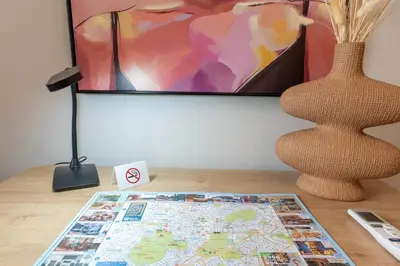a map on a table with a tv and a vase at Athenian Secret Key Residence in Athens