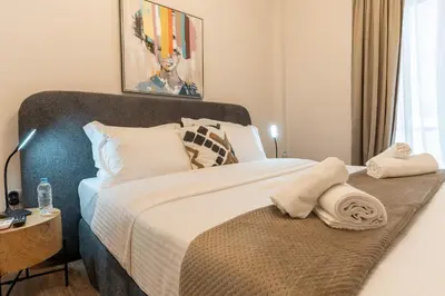 a bedroom with a large bed with towels on it at Athenian Secret Key Residence in Athens