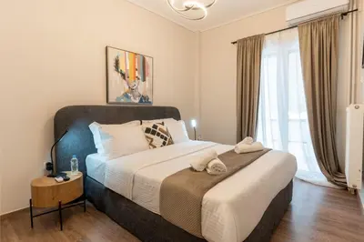a bedroom with a large bed and a window at Athenian Secret Key Residence in Athens
