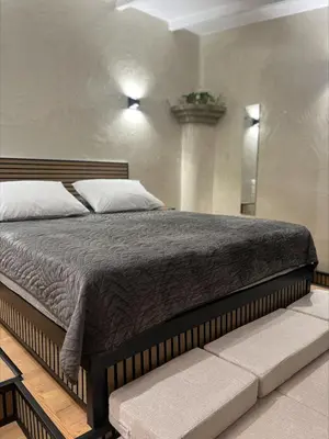 a bedroom with a large bed with avisor at Boutique Eptalofos 2 15min from airport and sea in Kouvarás