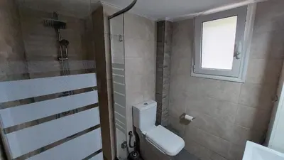 a bathroom with a toilet and a window at Kypseli is a Mood in Athens