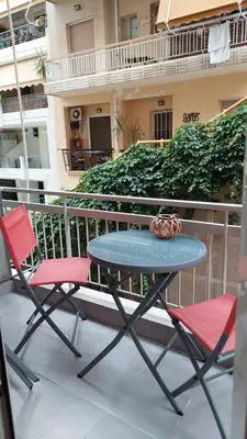a table and two chairs on a balcony at Kypseli is a Mood in Athens