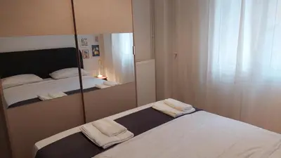 a bedroom with a mirror and a bed with towels at Kypseli is a Mood in Athens