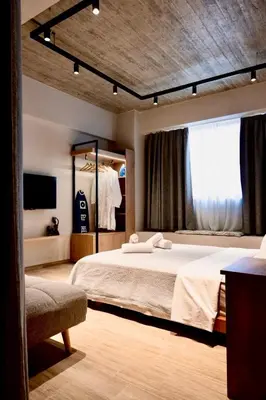 a bedroom with a large bed and a window at African Adventure Apartment in Piraeus