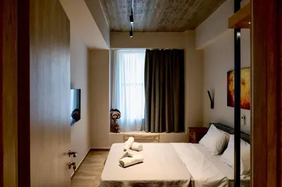 a bedroom with a bed with towels on it at African Adventure Apartment in Piraeus